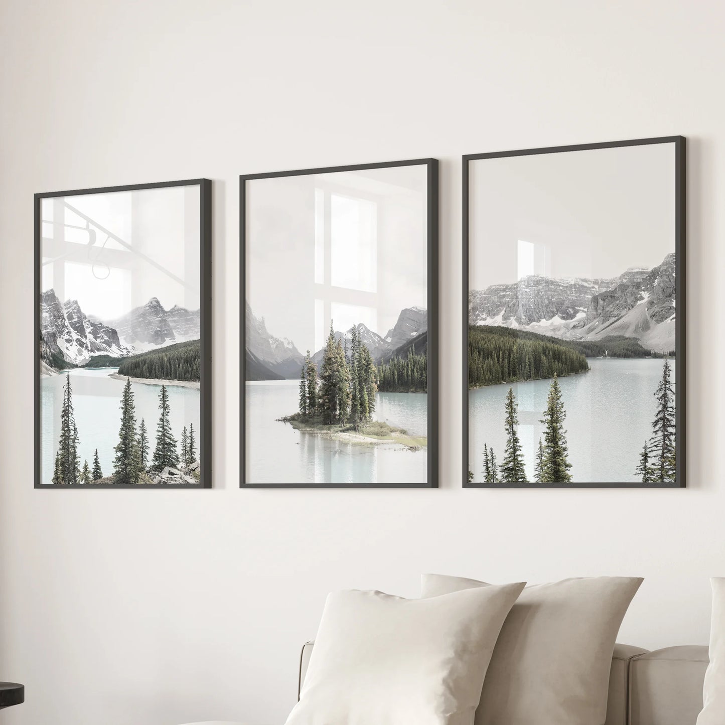 A trio of framed wall prints of the Canadian Rockies in black frames lines the space above the couch, bringing rugged calm to the family room.
