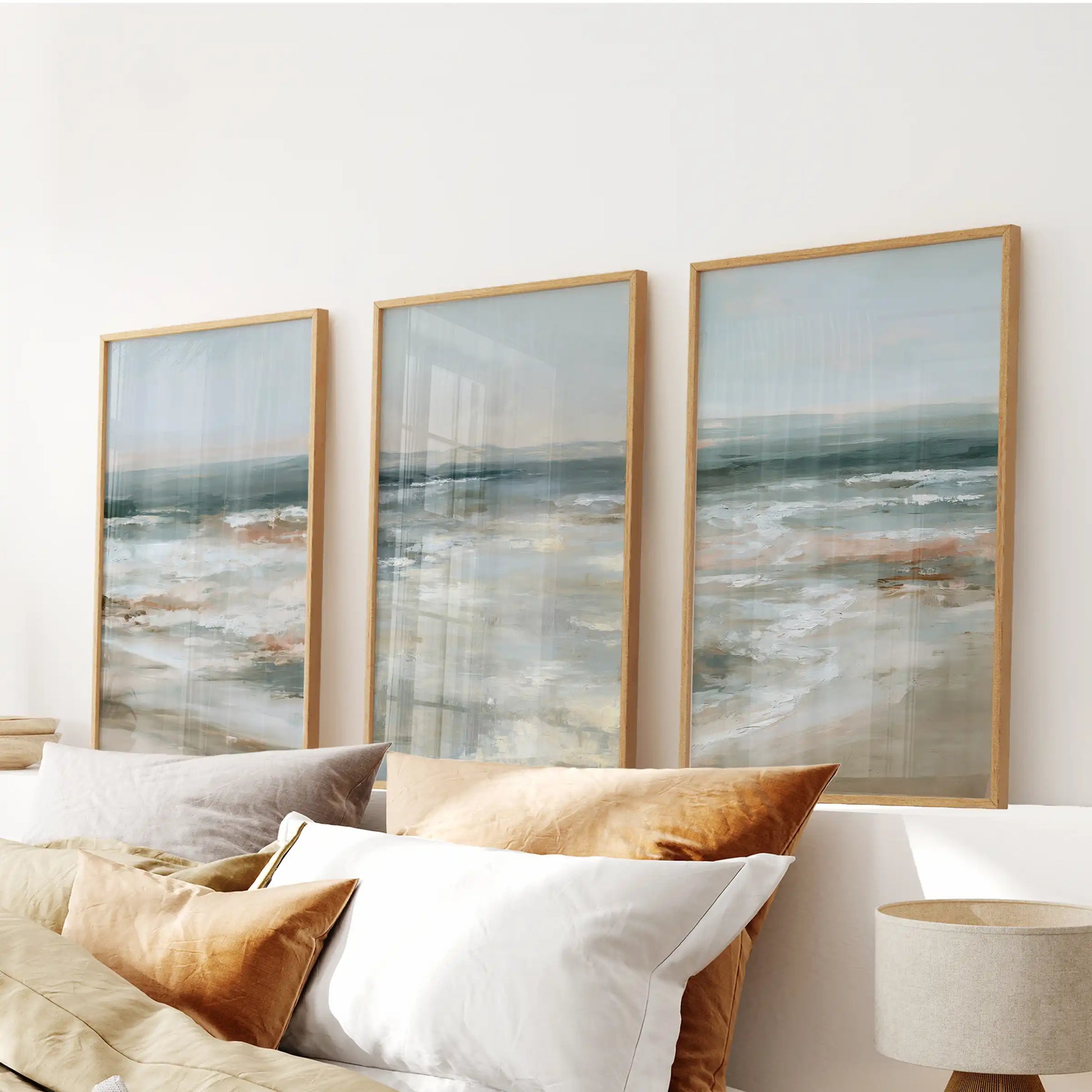 Gentle breaking waves 3-piece wall art in thin wood frames rides above the headboard, bathing the bedroom in calm, sea-glass blues.
