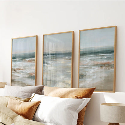 Gentle breaking waves 3-piece wall art in thin wood frames rides above the headboard, bathing the bedroom in calm, sea-glass blues.