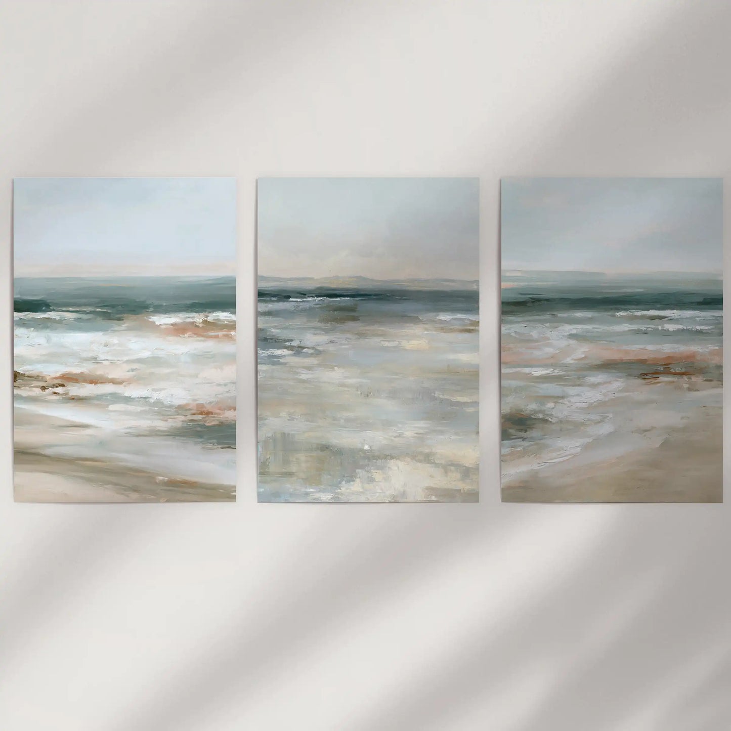 Misty ocean view set of three prints arrives as unframed wall art on a white wall, letting soft blues and the horizon feel light and clean.