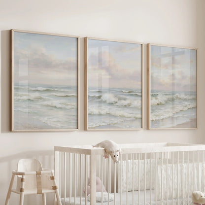 A wall art set of three sandy shoreline prints in light wood frames adds cozy coastal warmth to the nursery above the crib.