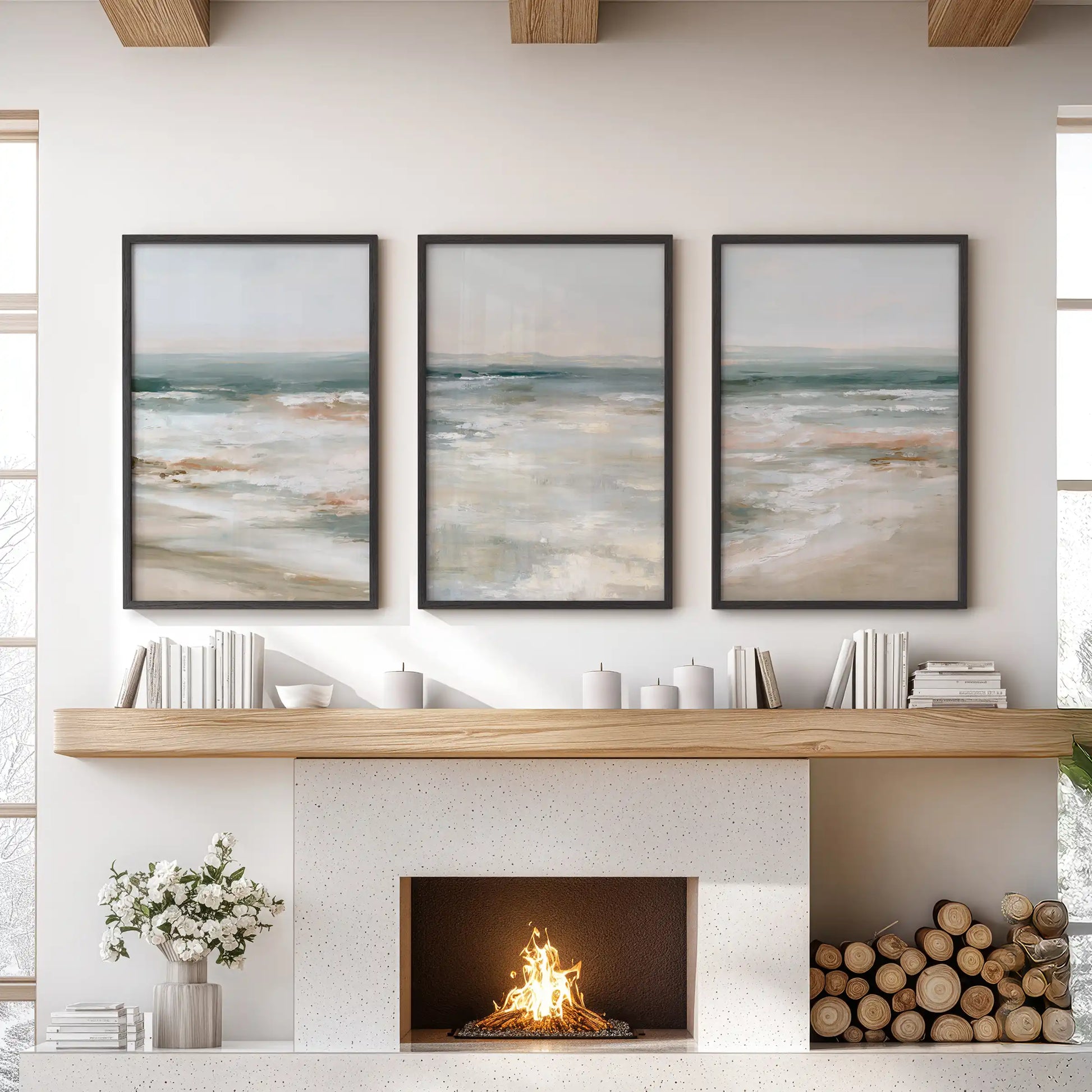Soft blue seascape wall art set of three in black frames rests over the fireplace, giving the living room a calm, coastal focal point.