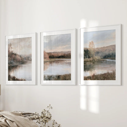 The three-piece picture set of autumn lake landscapes settles beside the bed, matted in white frames for a light, tranquil bedroom finish.