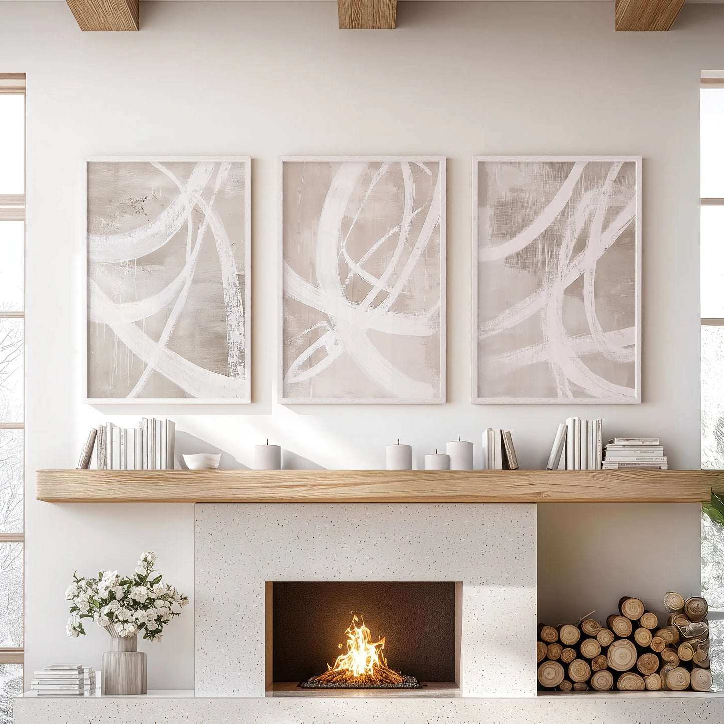 A 3-piece artwork in crisp white frames, featuring beige abstract motifs, spans the sitting-room wall above the fireplace.