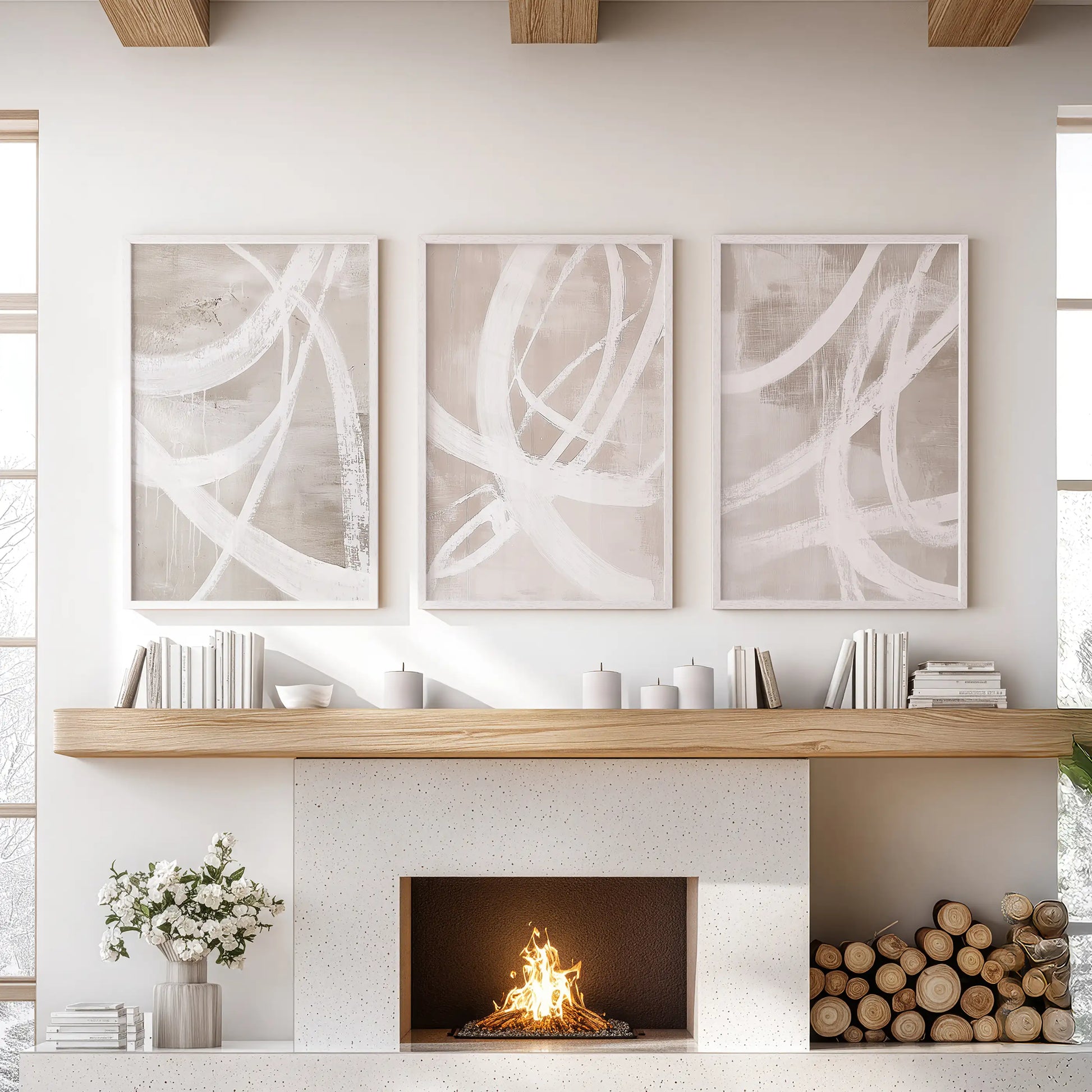 A 3-piece artwork in crisp white frames, featuring beige abstract motifs, spans the sitting-room wall above the fireplace.