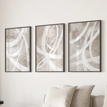 Set of three wall pieces featuring soft organic shapes in matte black frames gently align behind the living-room sofa.