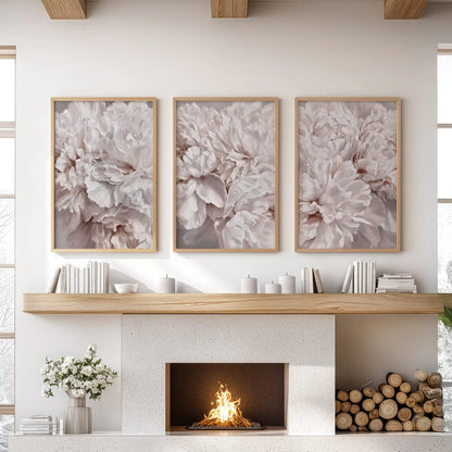Ruffled blush and ivory petals overlap throughout three oak-framed prints above a fireplace, with soft taupe shadows in the folds.