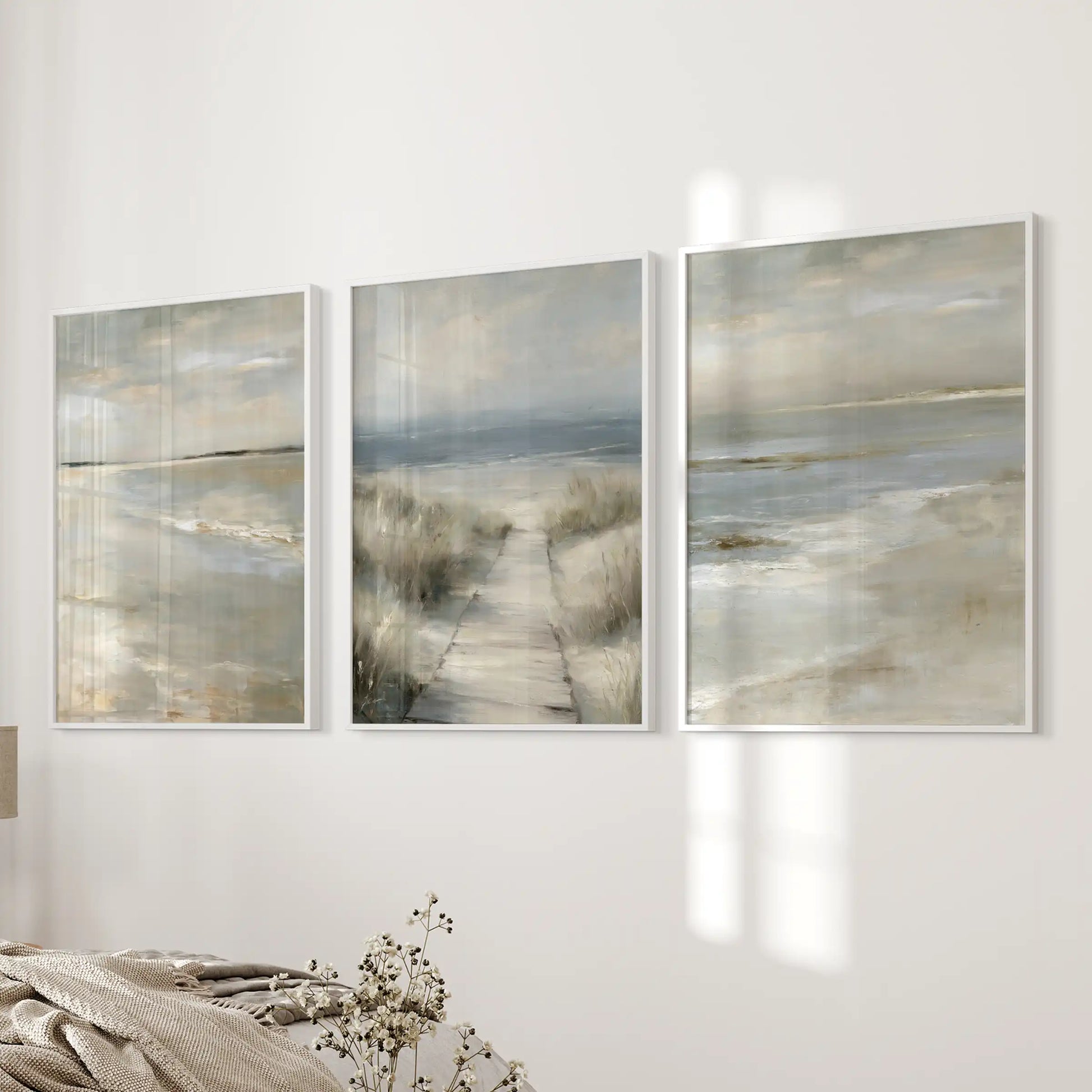 Serene ocean horizon 3-piece wall art, in crisp white frames, settles the bedroom wall with quiet coastal simplicity.