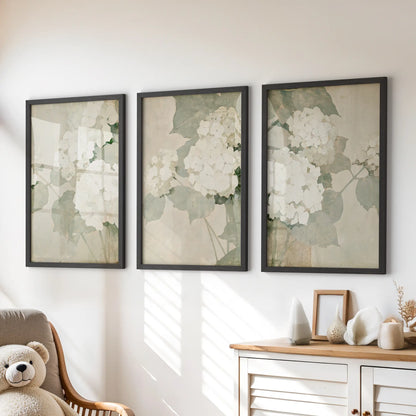 Soft white flowers feature on a three-piece poster set in black frames above a chest of drawers in a kids room.