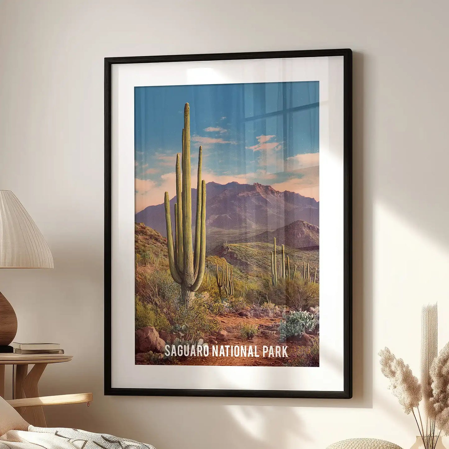 Blue-green desert sunset, one framed print with matting, sits by the accent chair in the living room in a crisp black frame.