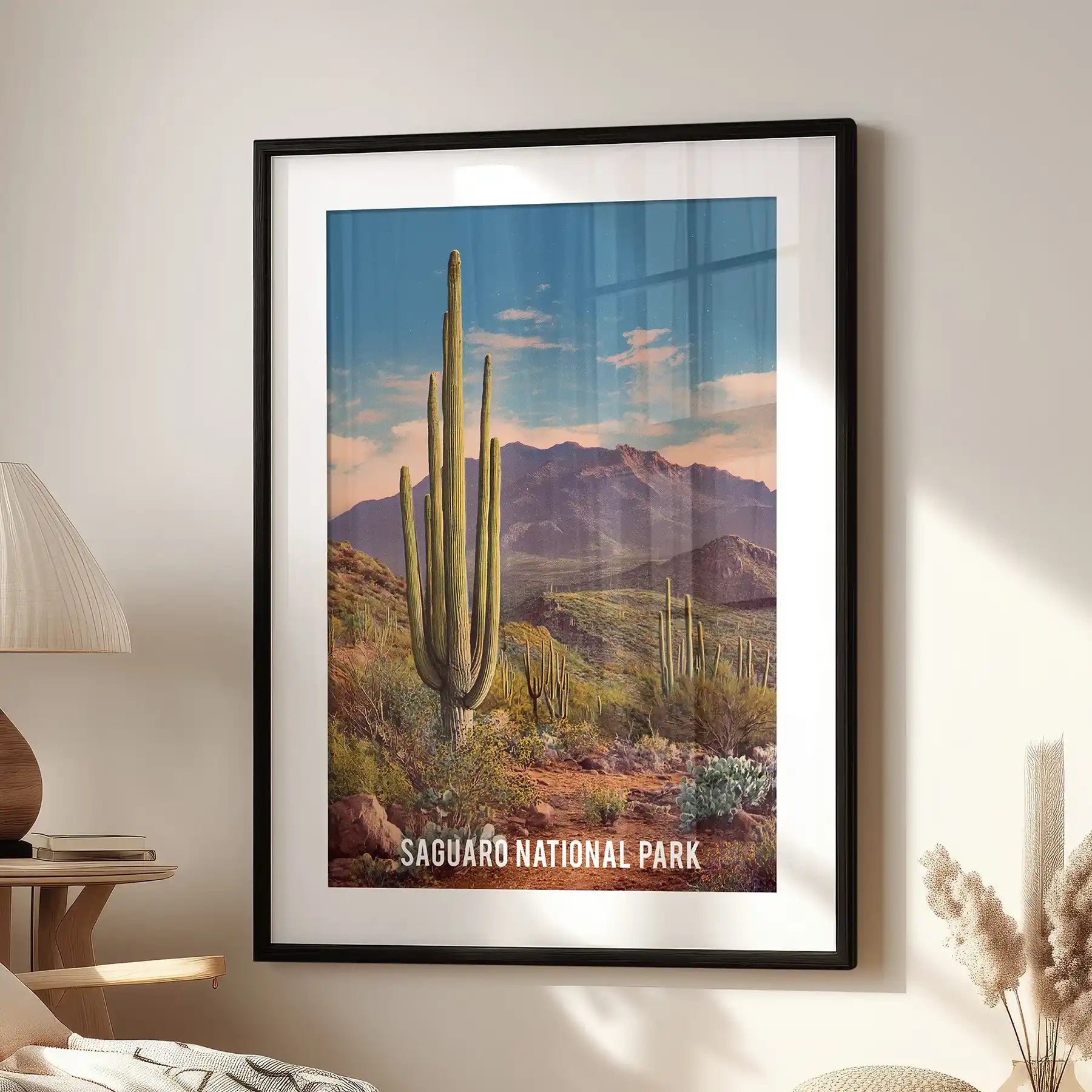 Blue-green desert sunset, one framed print with matting, sits by the accent chair in the living room in a crisp black frame.