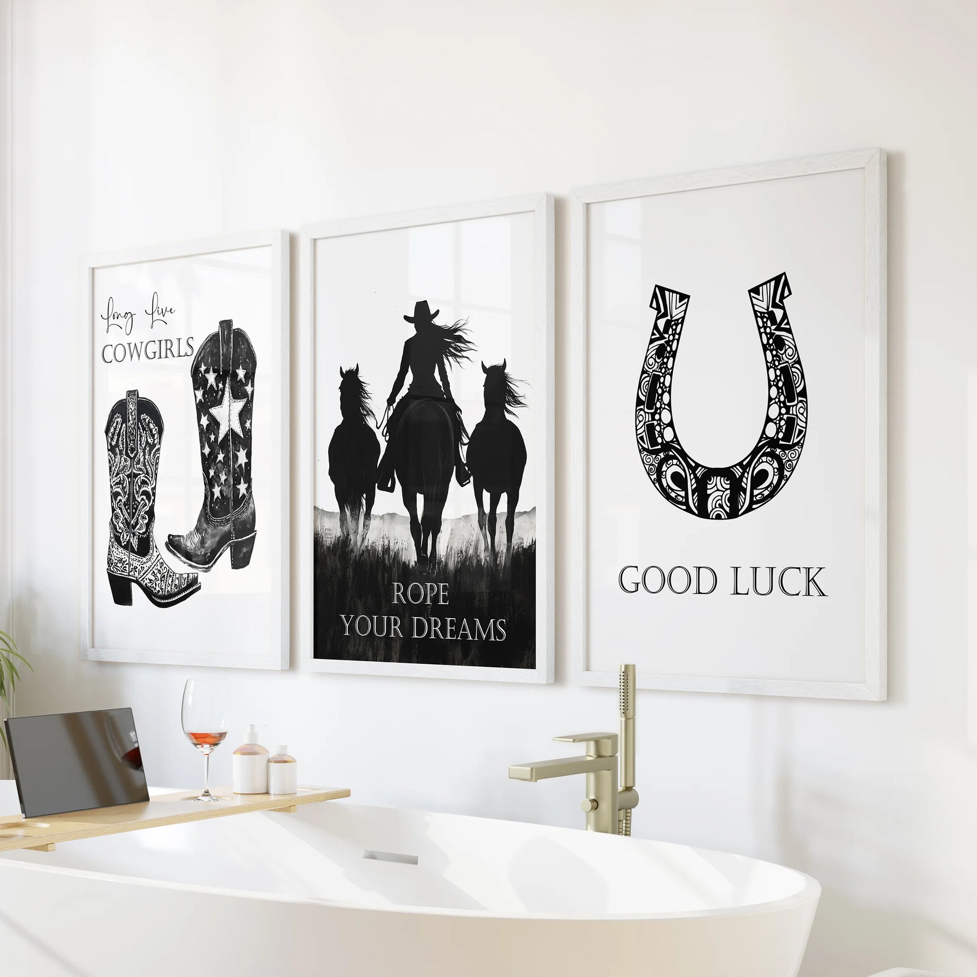 Wild West collage posters in a trio of wall art pieces sit in crisp white frames, adding a light Southwestern vibe above the bathtub in a fresh bathroom.