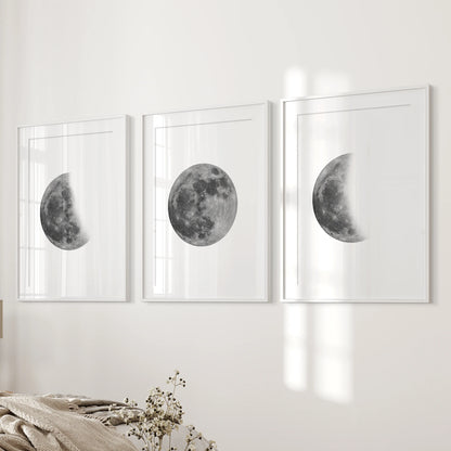 Three matted white-framed moon posters hang beside the bed, giving the bedroom a calm, gallery-like lunar finish.