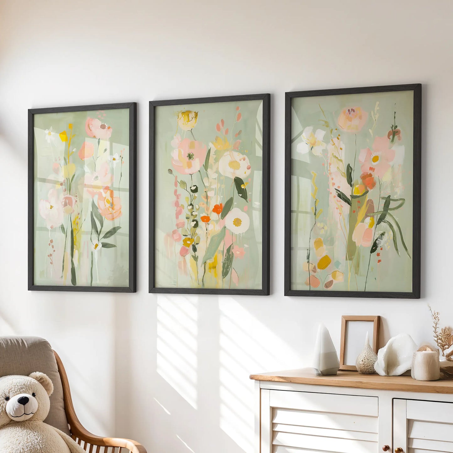 Colorful floral painting, a three-piece print set, brightens a kids playroom in black frames over the chest of drawers.