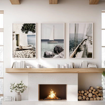 Sunlit marina wall art, three piece set, spans the space above the fireplace mantel in the family room, with clean white frames for an elegant coastal finish.