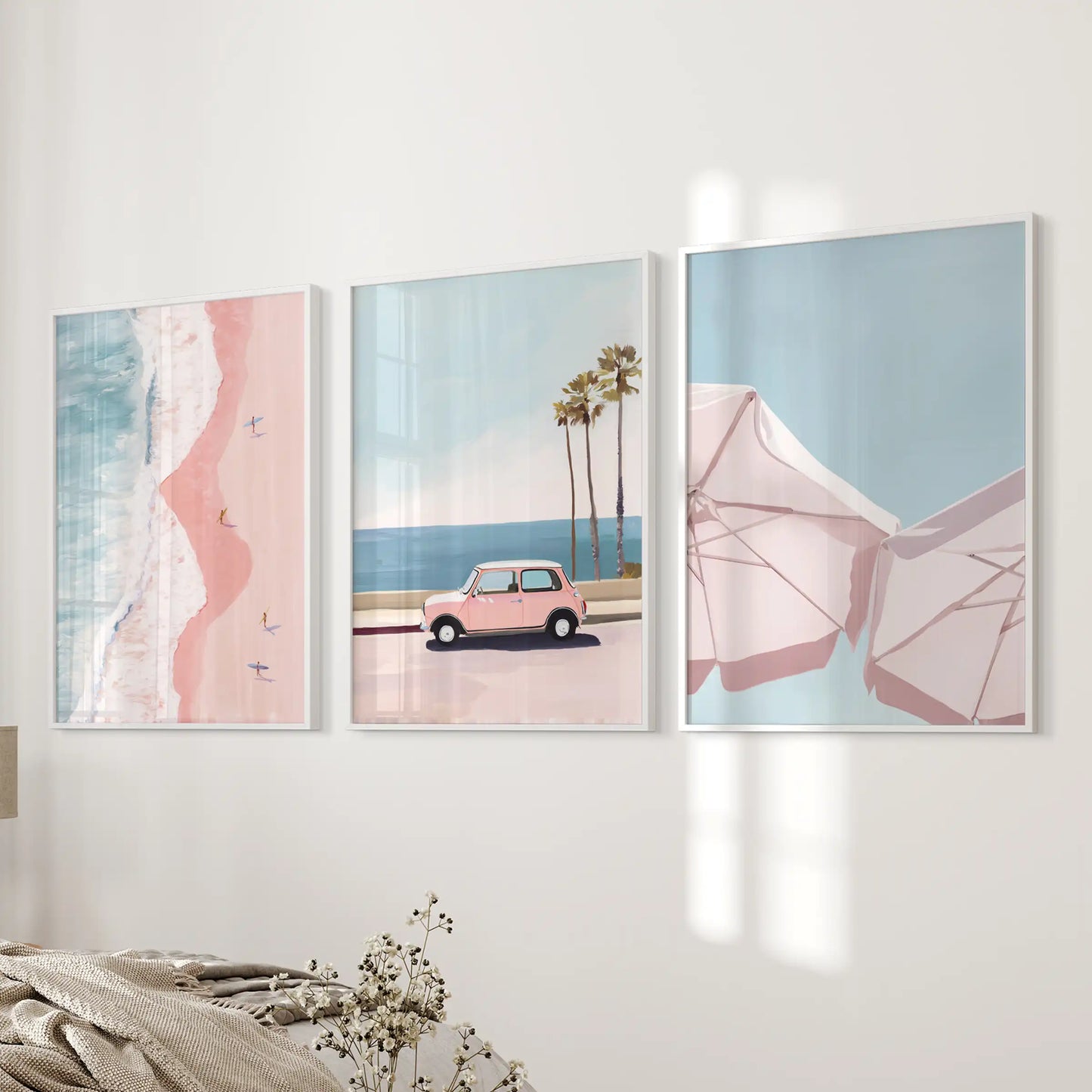 Pink coastal beach scenes, 3 wall art prints in crisp white frames, soften the near-bed wall and set a relaxed tone in the bedroom.