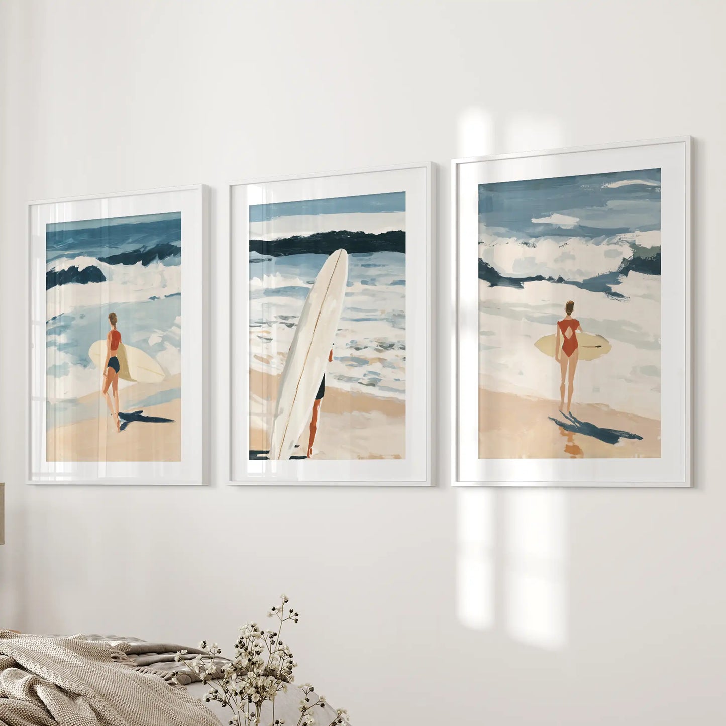 Ocean wave triptych, three-piece wall art set with white-matted frames, settles the bedroom wall with soft, tidal blues.