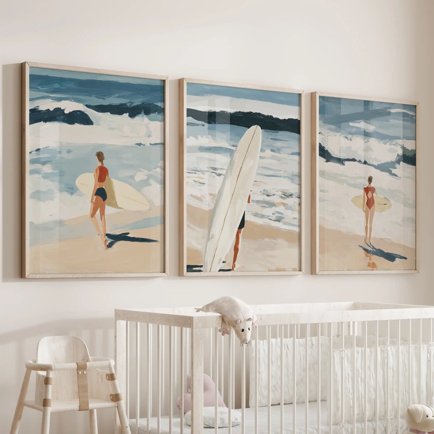 Three playful surfboard posters in natural oak frames keep the nursery fresh and bright above the cot.