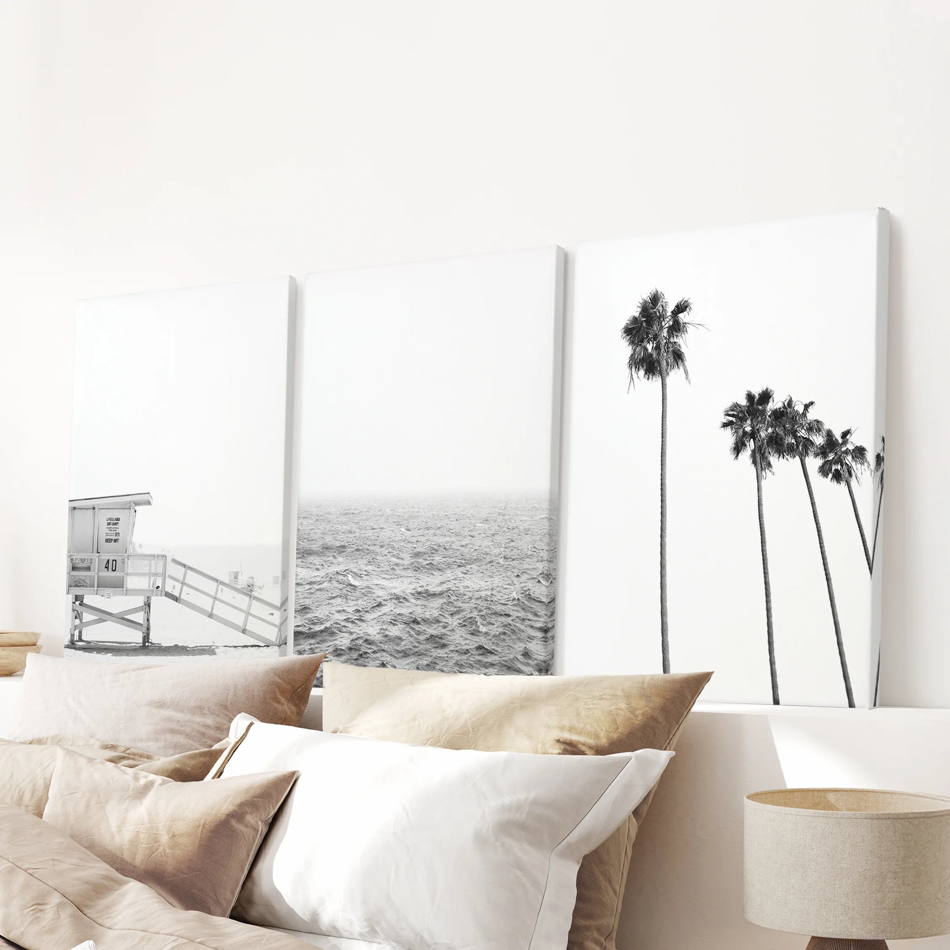 A three-piece wrapped canvas wall art set of summer ocean views hangs above the bedroom headboard, giving the space light coastal ease.