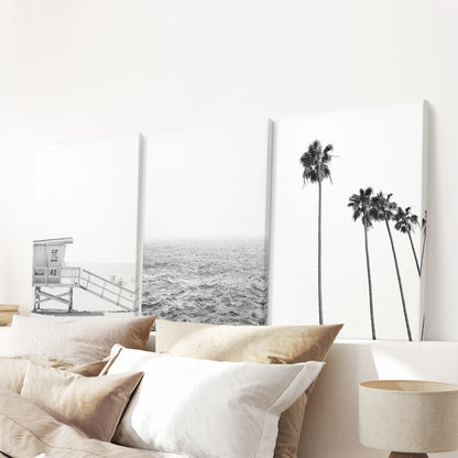 A three-piece wrapped canvas wall art set of summer ocean views hangs above the bedroom headboard, giving the space light coastal ease.