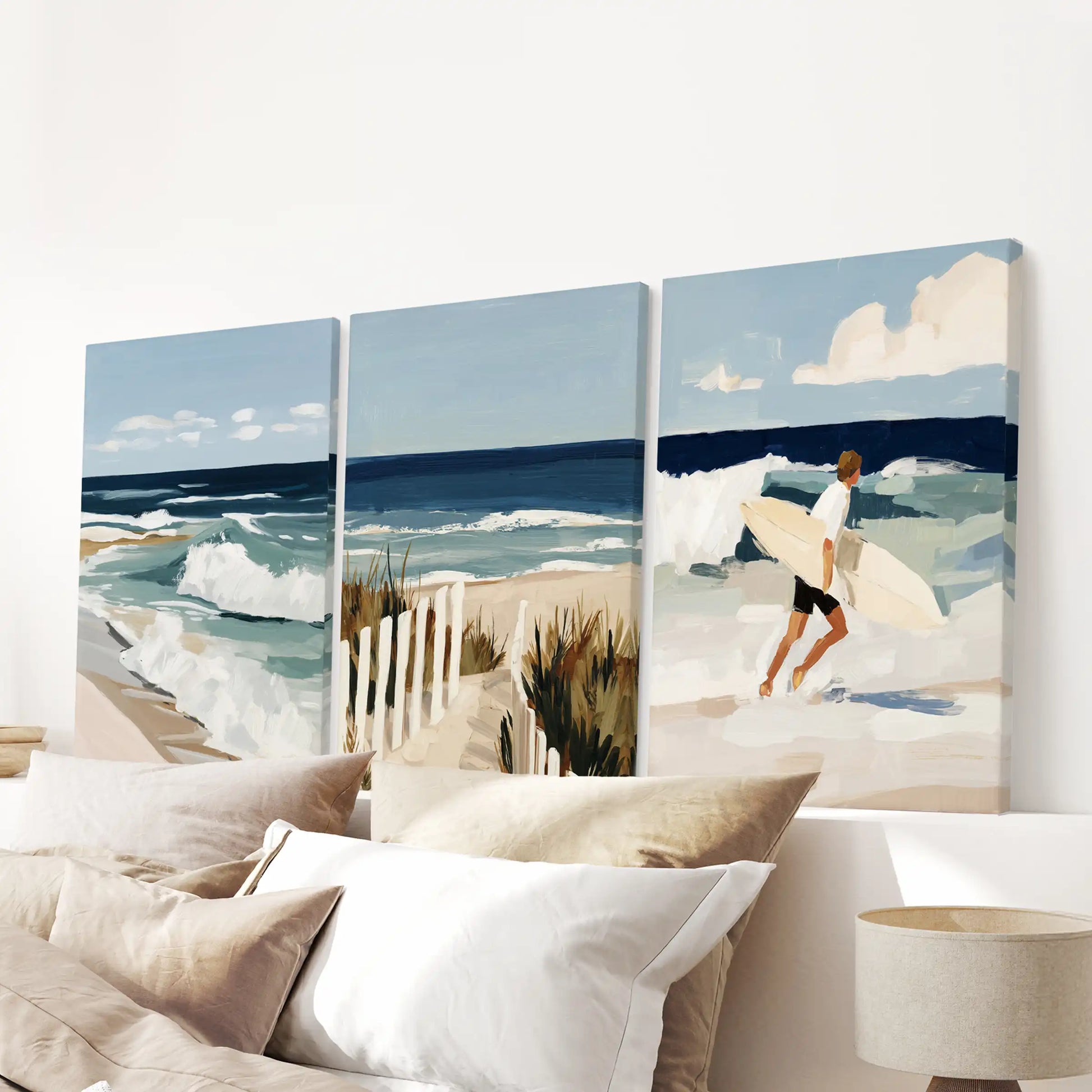A trio of ocean wave canvases with gallery wraps refreshes the bedroom wall above the headboard, bringing crisp seaside balance.