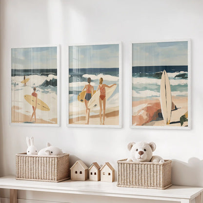 Women surfing artwork 3-piece print set, with white-framed prints, hangs above toy storage in a children’s room, playful and breezy without crowding the space.