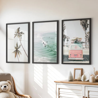Surfer riding waves set of three wall art energizes a kids room, with black framed prints lined up over the dresser.