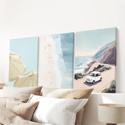 Three canvas beach-umbrella prints gather above the bed’s headboard, blending soft surf tones for bright, textured wall art.