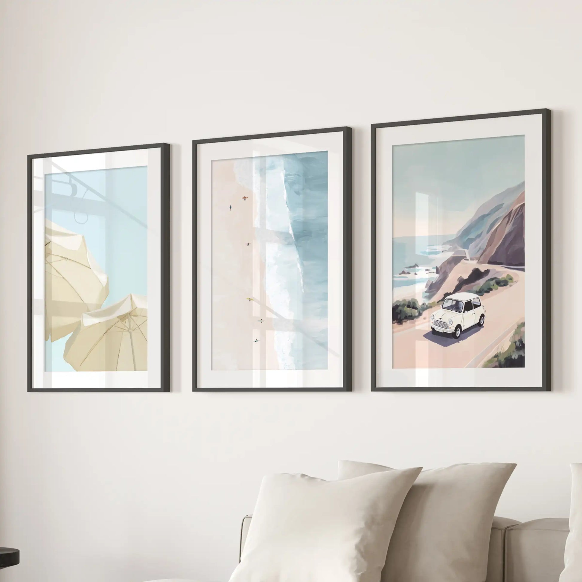 Ocean shoreline poster set of three in black frames with mats lends a crisp coastal note, designed to hang above the family-room sofa.