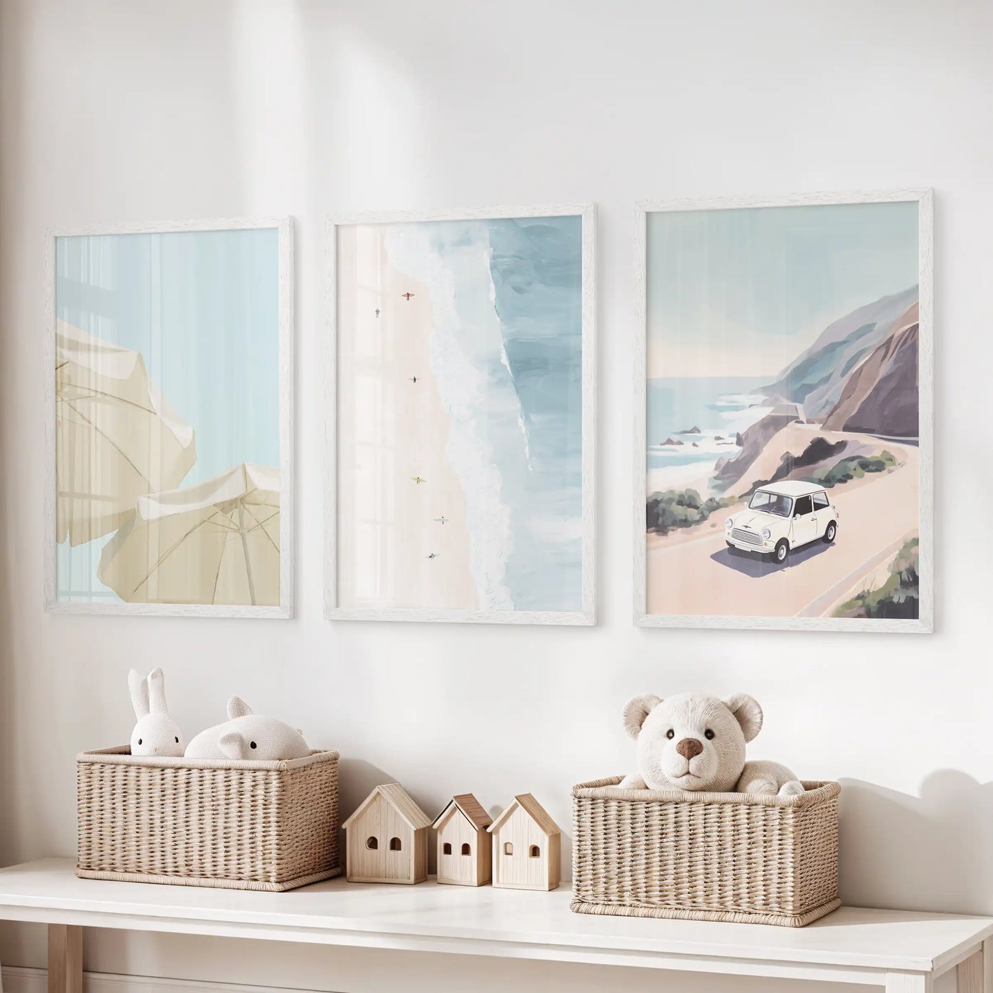 Pastel seaside landscape prints, a set of three in white frames, perch above the toy storage bench to soften a kids’ playroom.