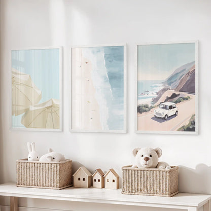 Pastel seaside landscape prints, a set of three in white frames, perch above the toy storage bench to soften a kids’ playroom.