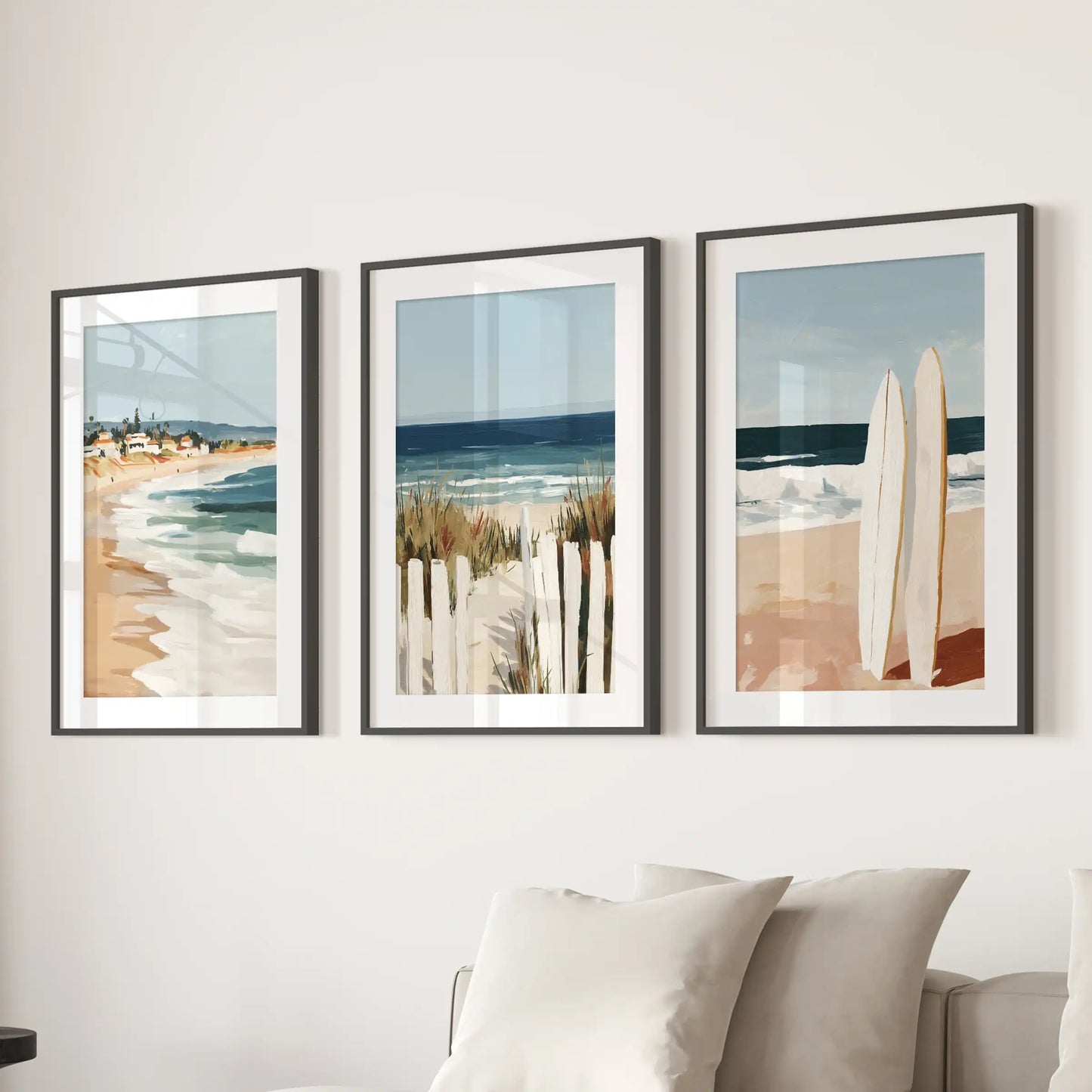 A trio of black-framed surfboard prints with white mats turns the wall over the family-room sectional into a breezy surf-culture gallery.