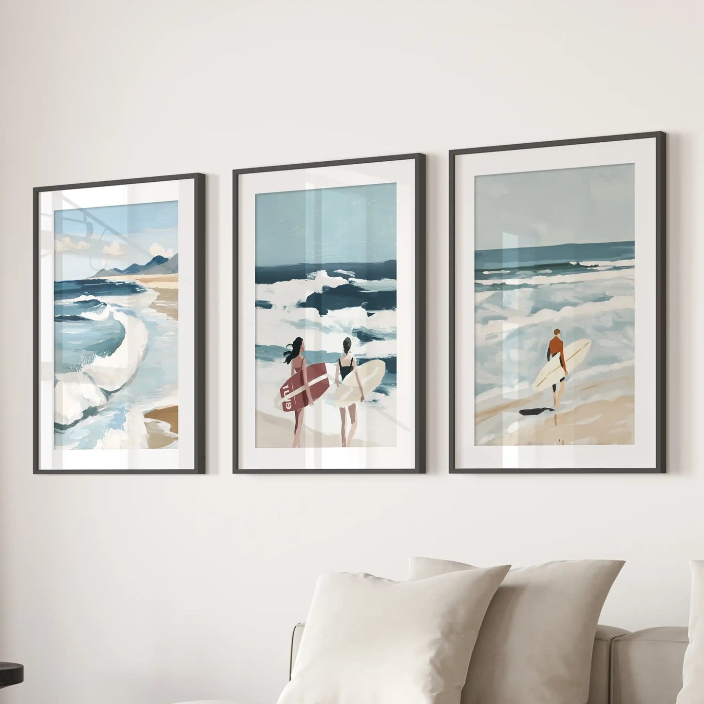Surfer-themed wall art trio in black frames with white mats is arranged above a couch, giving the sitting room a crisp, modern feel.