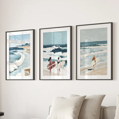 Surfer-themed wall art trio in black frames with white mats is arranged above a couch, giving the sitting room a crisp, modern feel.