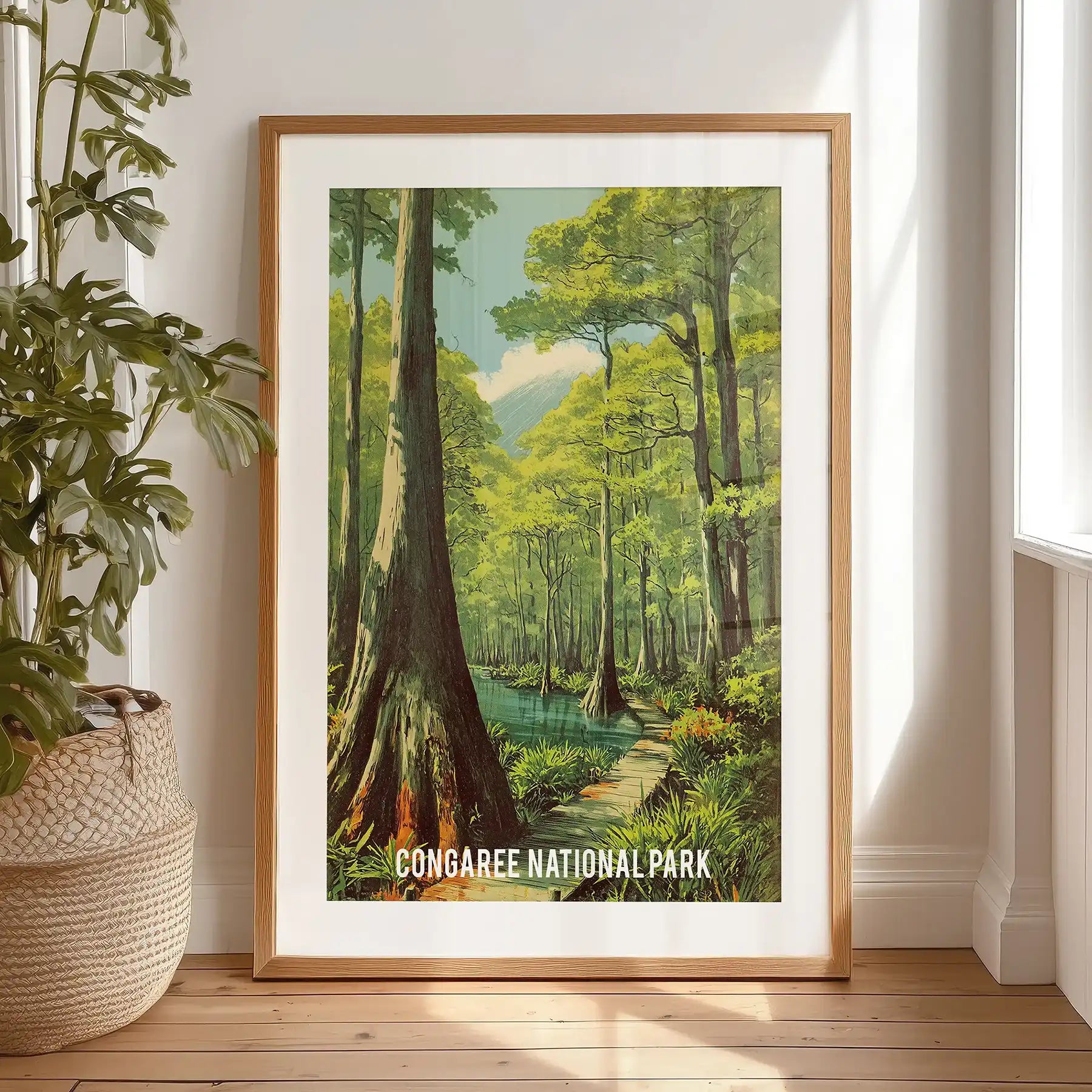 Swamp forest cypress trees large wall art, matted and set in a black frame, rests on the bedroom floor against the wall, dense greens ready to hang.
