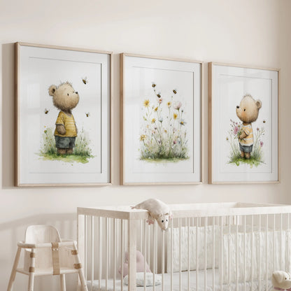 A warm nursery wall art trio with teddy bear prints in thin wood frames and mats hangs sweetly above the baby’s cot.