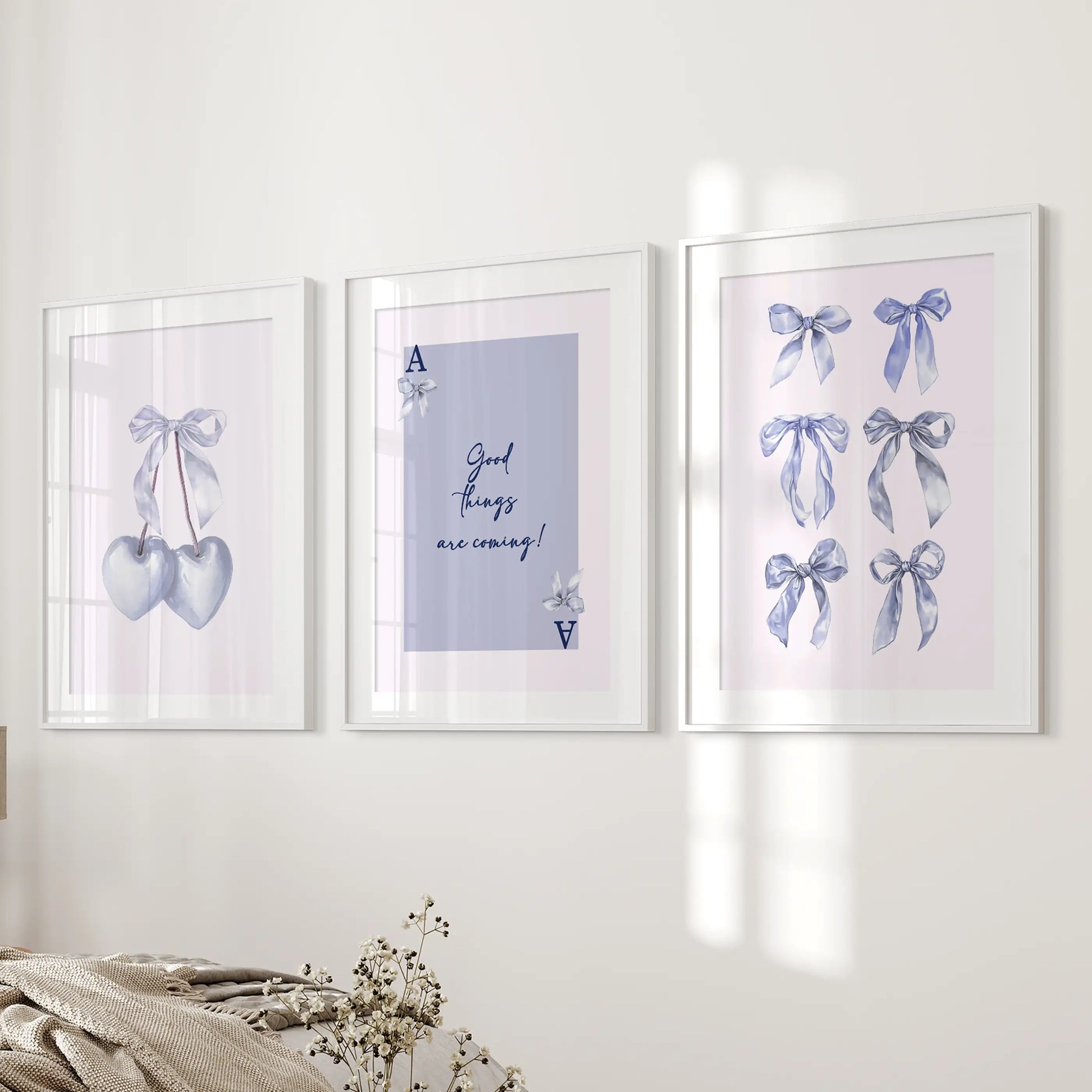Ace of Hearts playing card posters, poster trio, sit crisp in white frames with matting near the bed wall, layering cool light-blue charm into the bedroom.