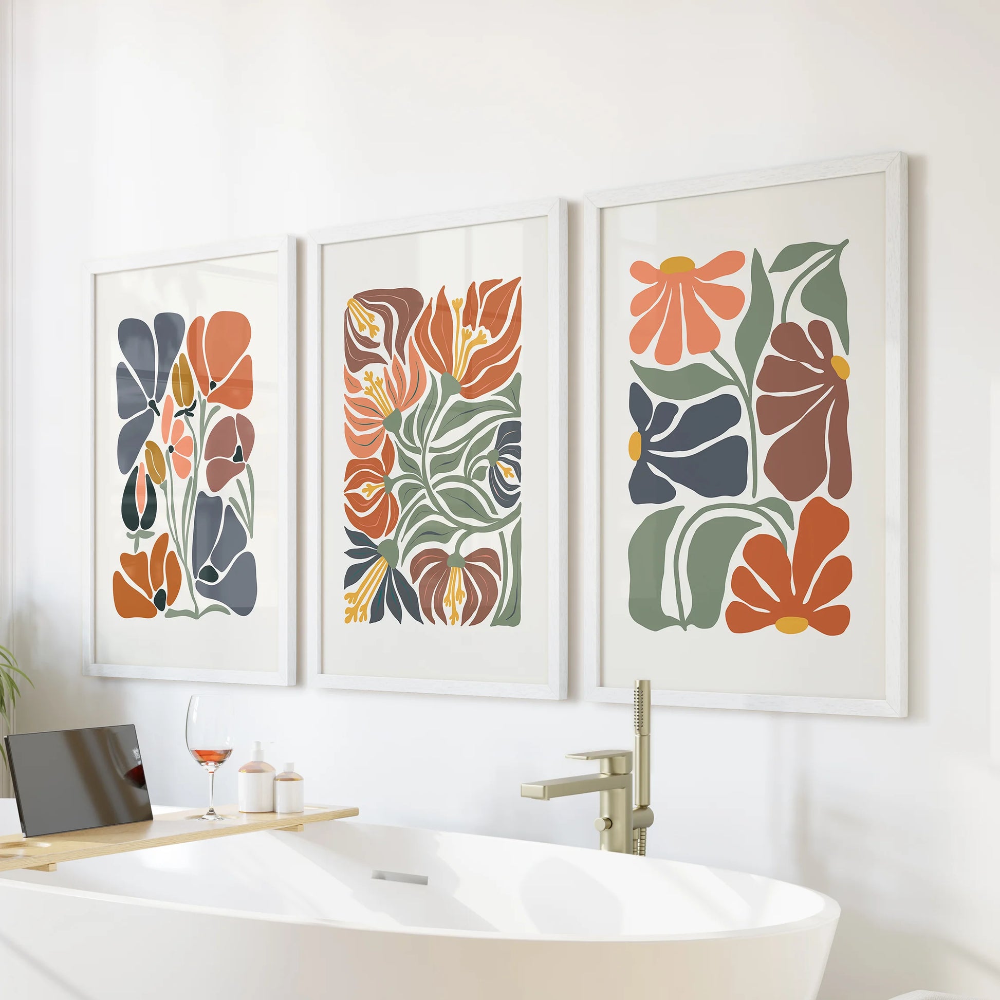 Minimalist plant wall art, a three-piece picture set in white frames, brings spa-calm terracotta notes to the bathroom wall over the bathtub.