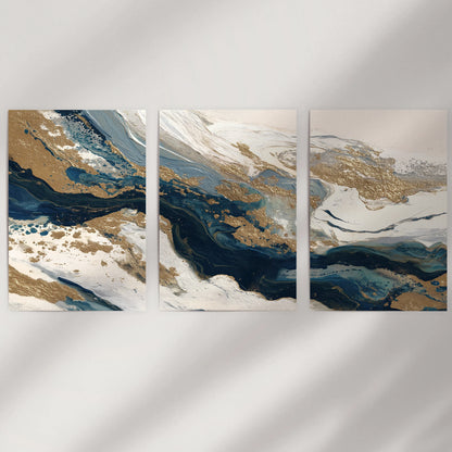 Elegant navy abstract brushwork, a poster trio, sits unframed on an empty wall, letting blue-beige gradients and soft gold accents breathe with airy ease.