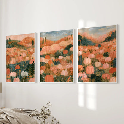 Three framed wall prints in white depict a cottagecore harvest scene, settling beside the bed with soft seasonal warmth.