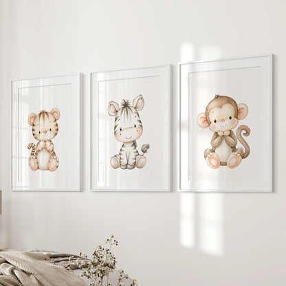Beside a bed, three prints in matted white frames show a seated tiger cub, zebra and monkey on plain white backgrounds.