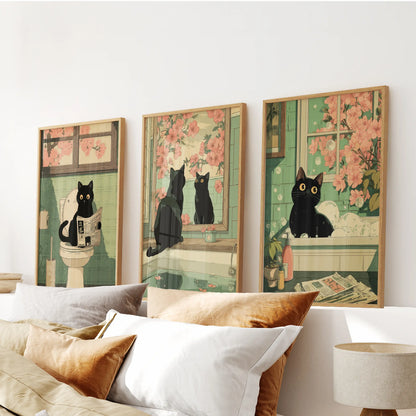 Three oak-framed art prints depict a playful black cat bathroom scene, hanging above a bedroom headboard for a cheerful centerpiece.