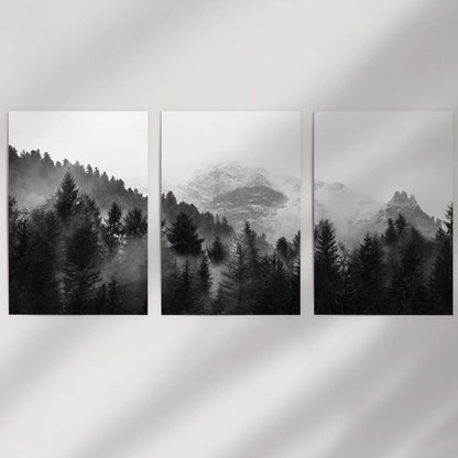A minimalist trio of unframed woodland art prints in monochrome adds quiet Nordic depth to empty wall space.
