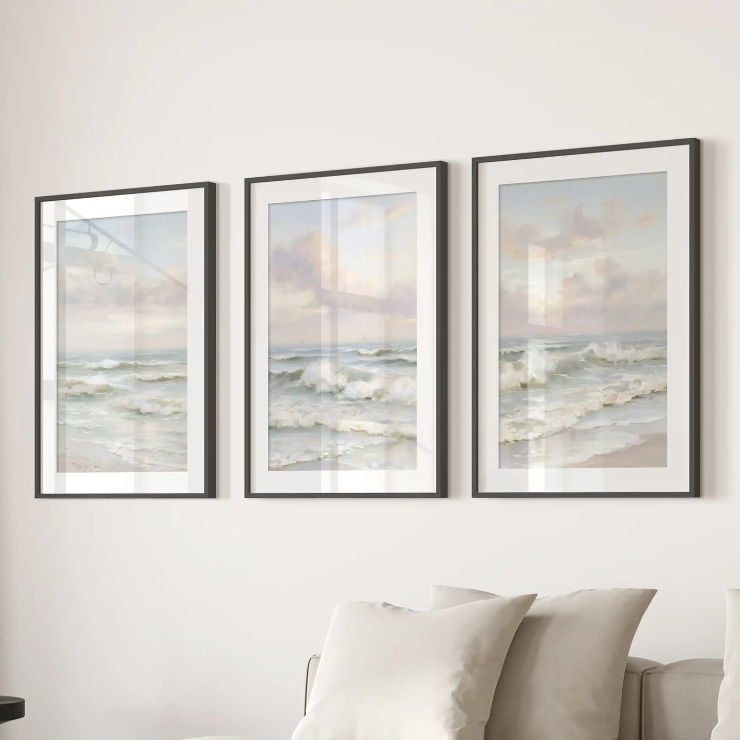 Neutral seascape horizons in a three-piece wall art set, presented in black frames with wide mats, create a refined coastal focal point above the family-room couch.