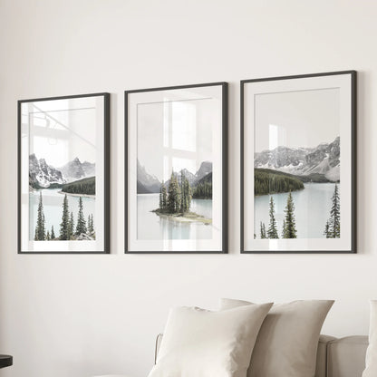 Three black-matted framed prints of an alpine lake reflection form modern wall art behind the sofa, balancing the living room with cool tranquility.