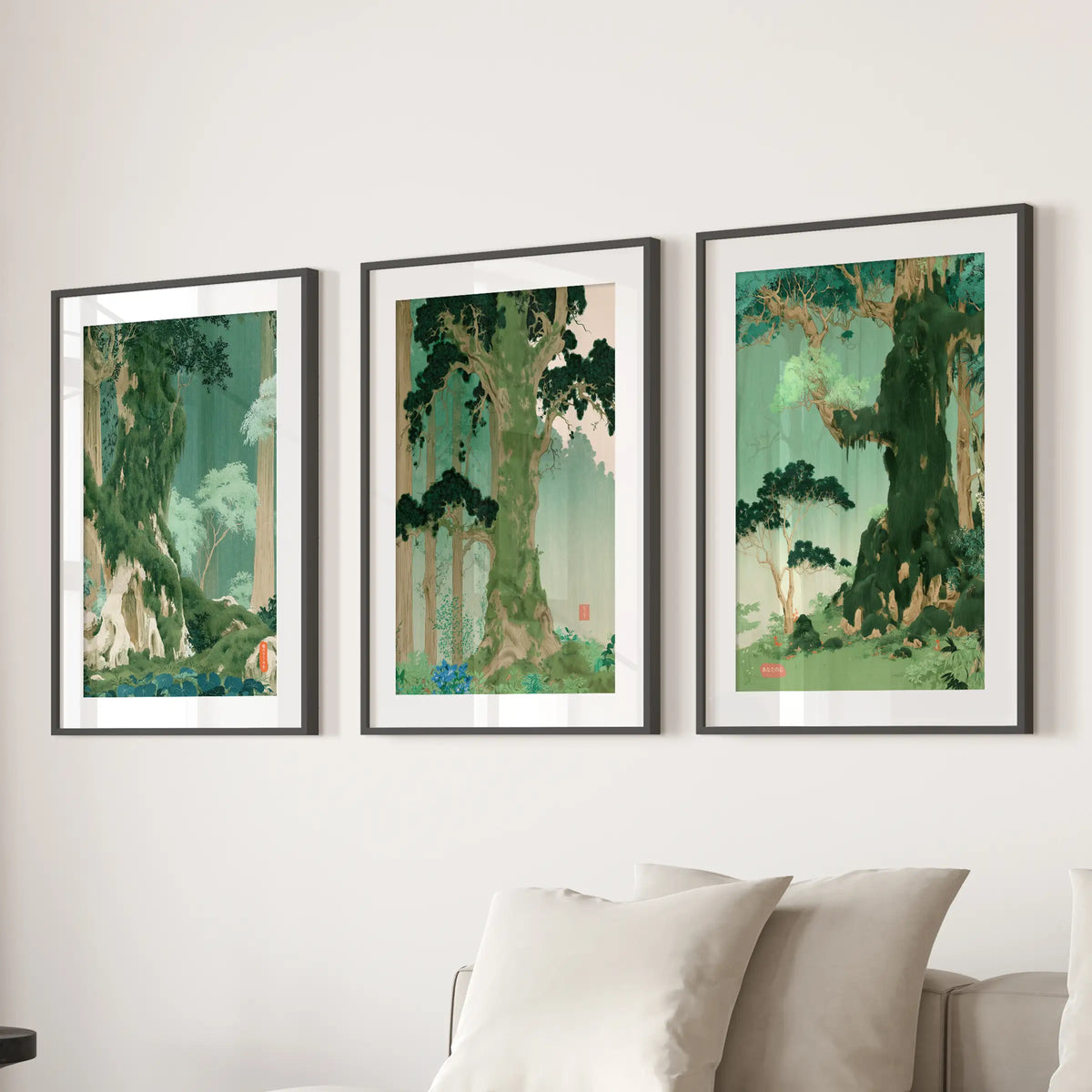 Woodland landscape wall art, a set of three prints, hangs above the family room sofa in black matted frames.