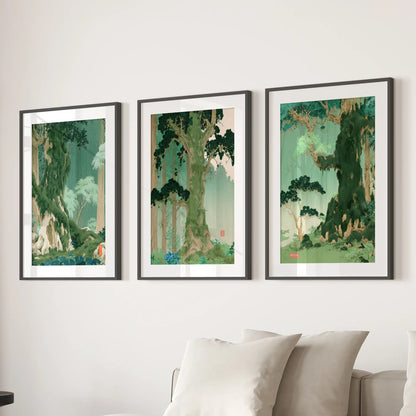 Woodland landscape wall art, a set of three prints, hangs above the family room sofa in black matted frames.