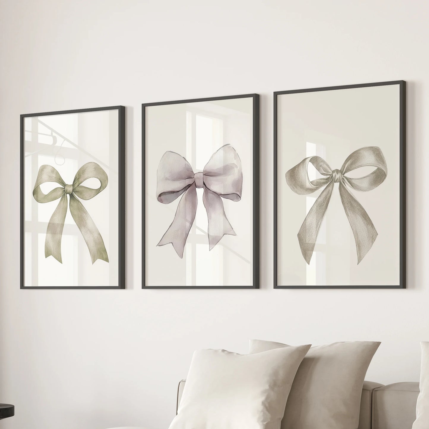 Cream ribbon posters, a three-poster set, float over the living room sofa in sleek black frames, bringing soft, coquette charm to neutral walls.