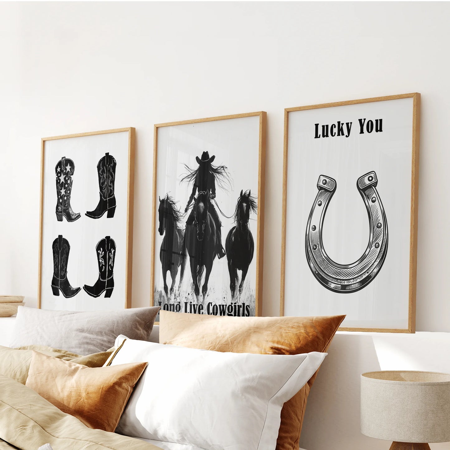 Southwestern cowgirl lifestyle scenes, a 3-piece picture set, warm the bedroom above the bed in natural wood frames that echo earthy desert tones.