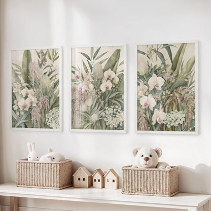The three white-framed prints above toy baskets show pale pink orchids, overlapping green leaves and small clusters of white flowers.